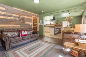 a living room with a couch and a kitchen at Norske Nooke - Experience the best of Big Bear Walk to Bear Mountain and the Golf Course in Big Bear Lake
