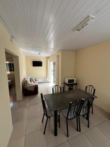 a dining room with a table and chairs in a room at Refúgio da Camboa - Casa Menta in Governador Celso Ramos +1 photo