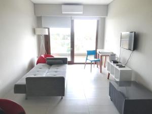 a living room with a couch and a tv at Canning Park premium apartment for 4 in Canning