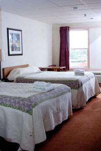 a hotel room with two beds and a window at Anchorage Inn Burlington in Burlington
