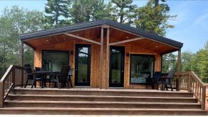 a wooden cabin with a table and chairs on a deck at Pine Mountain Resort in Iron Mountain +171 photos