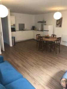 a kitchen and dining room with a table and chairs at Joli appart au cœur du village in Castillon-en-Couserans