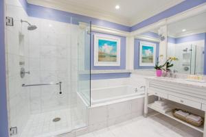 a bathroom with a tub, toilet, sink and mirror at The Beach Club at Charleston Harbor Resort and Marina in Charleston