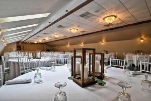 a banquet hall with white tables and chairs and candles at Four Seasons Island Resort in Pembine +89 photos