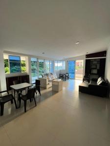a living room with a table and a fireplace at Apartamentos Pinos del Rodadero in Santa Marta