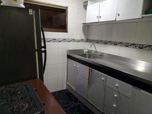 a small kitchen with a sink and a stove at Sharly House in Cartagena de Indias
