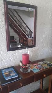 a table with a mirror and a candle on it at Green Fountain Villa 5 in Port Alfred