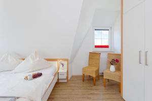 a bedroom with a bed and a table and chairs at Haus 113, Birkenweg 6 a in Ostseebad Karlshagen