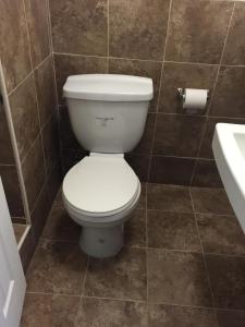 a bathroom with a white toilet and a sink at Roxy Hotel in Los Angeles