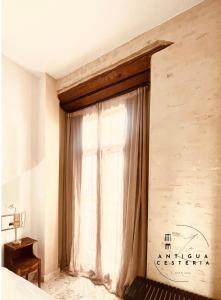 a window in a room with a curtain at Antigua Cestería in Seville +9 photos