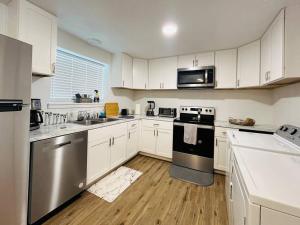 a kitchen with white cabinets and stainless steel appliances at WesterHaven- 2 bd Garden Level in Nampa