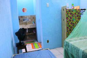 a room with a bedroom with a bed and a book shelf at Casinha do Pedro - I love Boipeba in Ilha de Boipeba