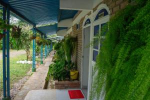 un edificio cubierto de hiedra con una puerta blanca en Club Campestre Manantial, en Medina 17 fotos más