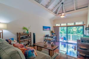 a living room with a couch and a table at Paniolo 210B in Princeville