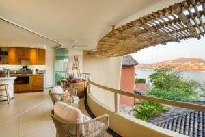 a kitchen and living room with a view of the ocean at Villas Kaukan by Tasman in Zihuatanejo +122 photos