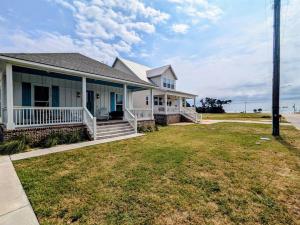 a house with a lawn in front of it at Tegarden Cottage at Gulfport Beach in Gulfport