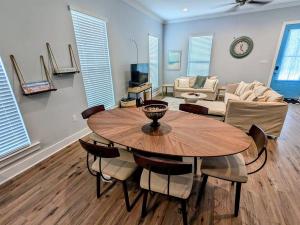 a dining room with a table and a living room at Tegarden Cottage at Gulfport Beach in Gulfport