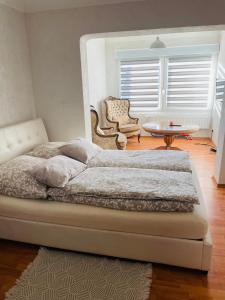 a bedroom with a bed and a table and a chair at Apartment Marielena in Püttlingen