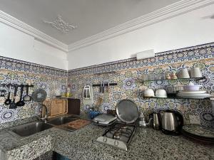 a kitchen with a sink and a counter top at Surfstay-Taghazout in Taghazout