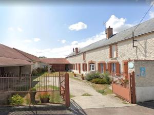 an old brick house with a gate in front of it at Charmante Longère Gâtinaise - Cour et Jardin Clos, Proche Paris et Orléans - FR-1-590-73 in Sceaux-du-Gâtinais