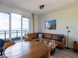 a living room with a table and a couch at Apartment in Sint-Annaland near Marina in Sint Annaland