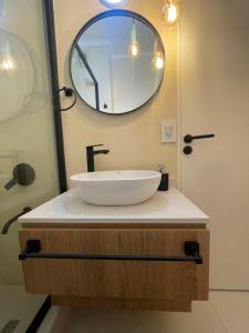 a bathroom with a white sink and a mirror at Obelisco Haus in Buenos Aires +17 photos