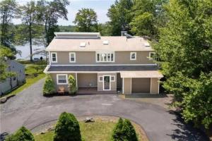 an aerial view of a house with a driveway at 5-Bedroom Lakefront, private beach wifi AC boat & in Tobyhanna
