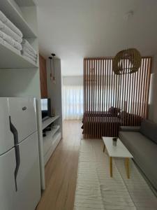 a living room with a couch and a refrigerator at Obelisco Haus in Buenos Aires