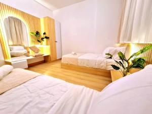 a bedroom with two beds and a mirror at Madinaty Elite Living Apartment in New cairo