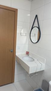 a white bathroom with a sink and a mirror at Apart Hotel Neri in Sinop +3 photos