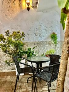 a table and chairs on a patio with plants at Casa Centro Historico Hotel in Cartagena de Indias