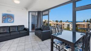 a living room with a couch and a table at Centrepoint Unit 27 in Caloundra