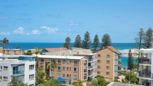 a group of apartment buildings with the ocean in the background at Centrepoint Unit 27 in Caloundra