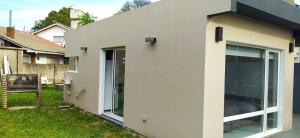 Casa la florida في مار ديل بلاتا: منزل أبيض مع أبواب زجاجية منزلقة كبيرة