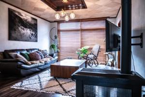 uma sala de estar com um sofá e uma mesa de centro em NIKI HOUSE -Yoichi 貸切一軒家 em Kurokawamachi