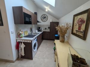 a kitchen with a sink and a washing machine at Charmant gîte près d'Orléans avec jardin privatif et parking - FR-1-590-524 in Chaingy +18 photos
