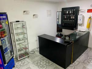 a shop with a cash register next to a refrigerator at Habitación doble, con desayuno - La Casona Hotel in La Pintada