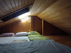 a bedroom with two beds in a wooden room at Mountain Apartment Vlašić Babanovac in Vlasic