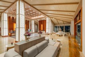 a large living room with a couch and tables at Katathani Phuket Beach Resort - SHA Extra Plus in Kata Beach