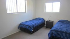 Ένα ή περισσότερα κρεβάτια σε δωμάτιο στο Surfside One Unit 1