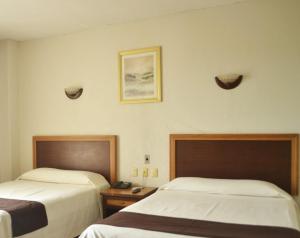 Postel nebo postele na pokoji v ubytování Hotel ARCADIO