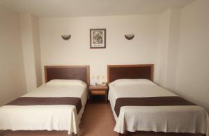 Postel nebo postele na pokoji v ubytování Hotel ARCADIO + 2 fotografie