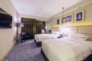 Voodi või voodid majutusasutuse Metropark Hotel Macau toas
