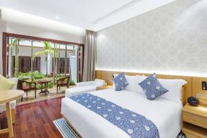 Voodi või voodid majutusasutuse Wafaifo Resort Hoi An toas
