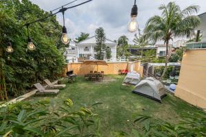 a backyard with a tent and a table and chairs at 6BR Homestay KL Pool Villa - 4KM To KLCC by Verano in Ampang