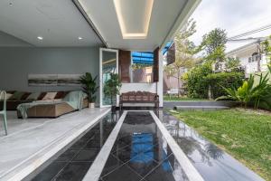 a courtyard with a pool and a house at 6BR Homestay KL Pool Villa - 4KM To KLCC by Verano in Ampang