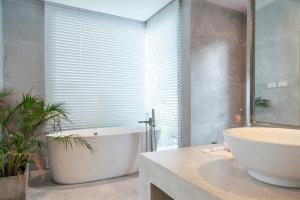 a bathroom with a tub and a toilet and a sink at Seaview Dreamscape Villa in Amphoe Koh Samui +44 photos