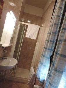 a bathroom with a shower and a toilet and a sink at Hotel Cinzia in Savignano sul Panaro