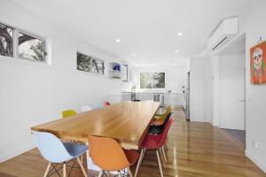 a dining room with a wooden table and chairs at Banksia Beach Retreat in Blairgowrie