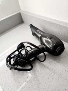 a hair dryer sitting on a counter top at Charming & Compact Retreat in St. Albert